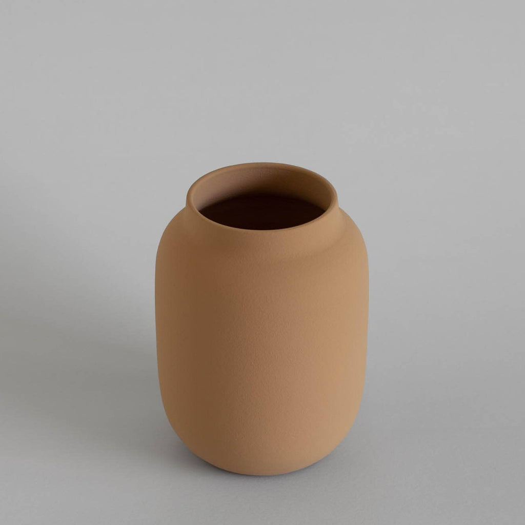 Brown ceramic vase on a gray background