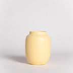 Yellow vase on a light gray background