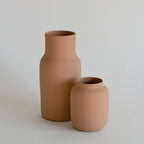 Two terracotta vases on a light gray background