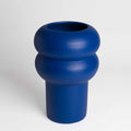 Blue vase with a unique design on a white background