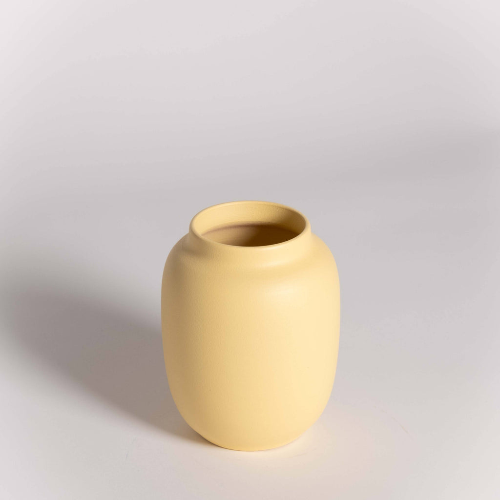 Yellow vase on a light gray background