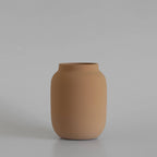 Brown ceramic vase on a light gray background