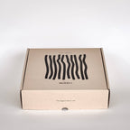 Cardboard box with wavy line design and 'minori' branding on a white background